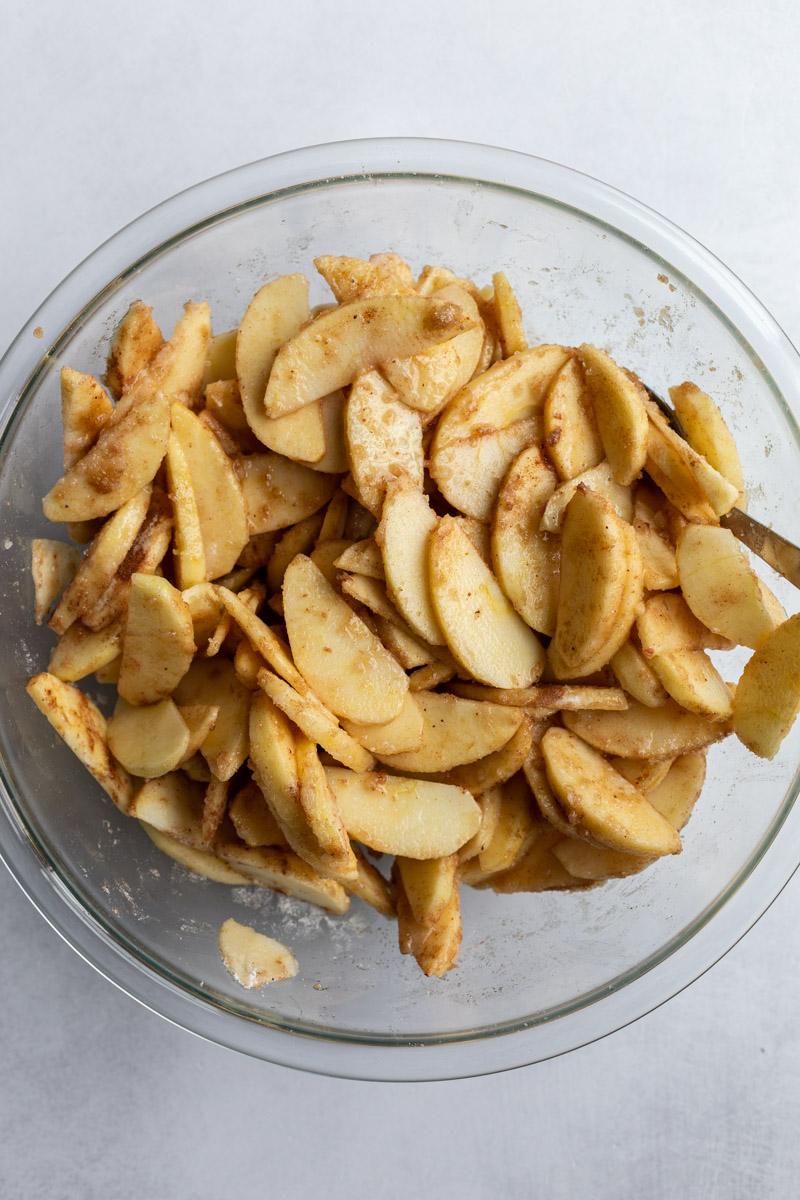tossing apple slices with sugar