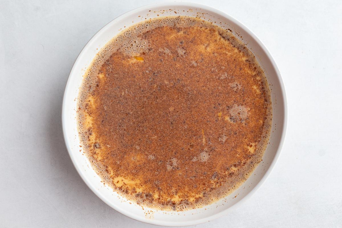milk, eggs, and spices whisked together in a wide bowl to make french toast