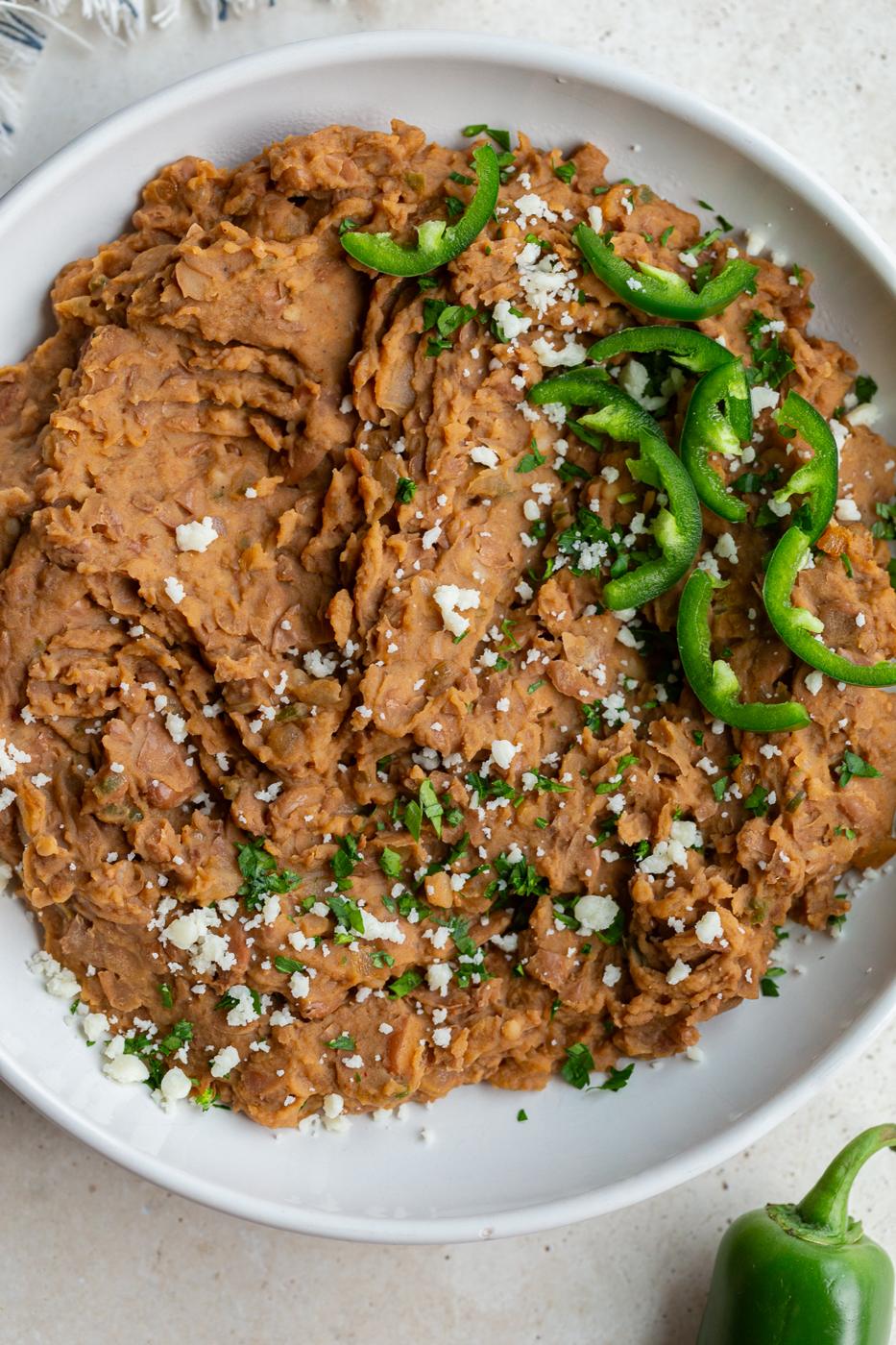 kitchen-made refried beans in a large white bowl
