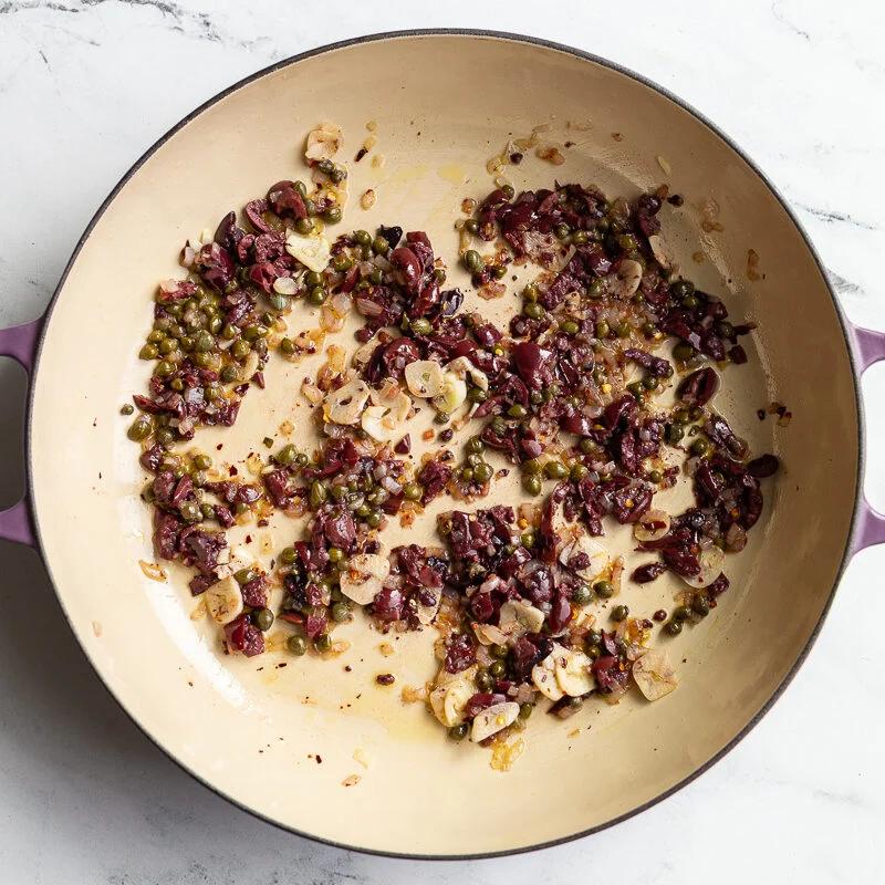olives and capers sauteed in a skillet