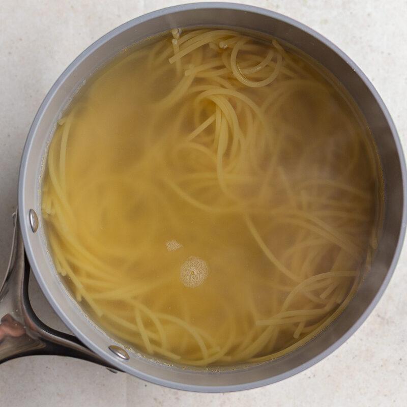 spaghetti cooked in a pot with water