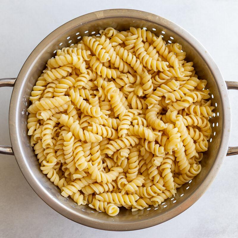 cooked rotini pasta in a colander