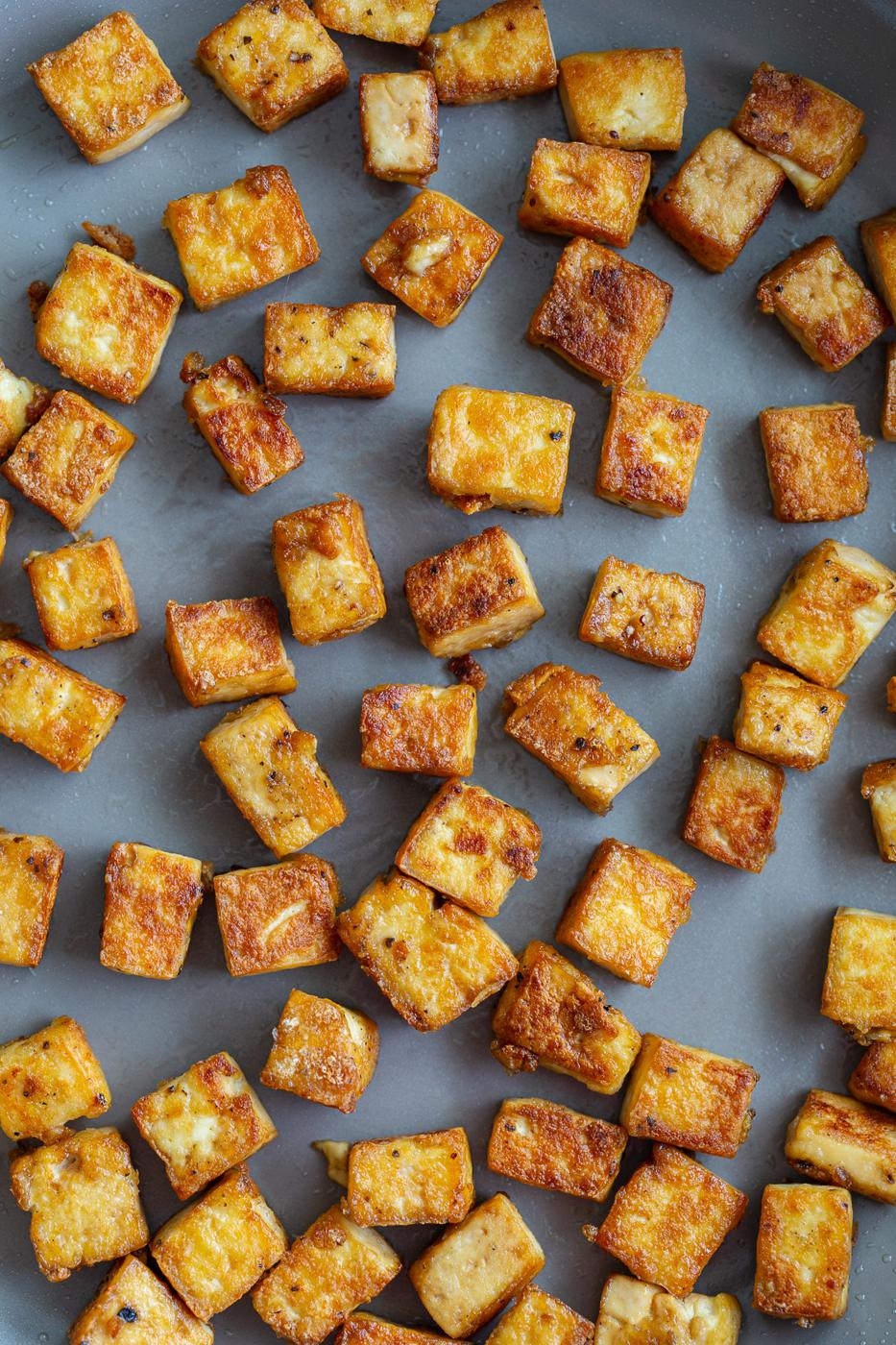 up close shot of crispy tofu in a large skillet