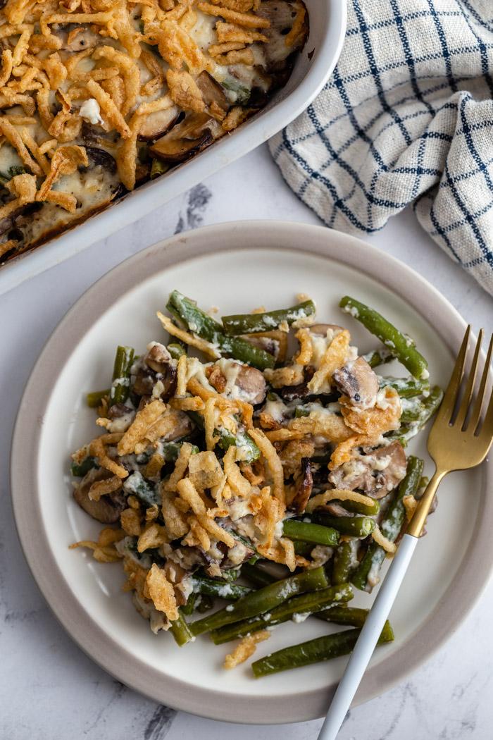 green bean casserole on a plate topped with fried onions.
