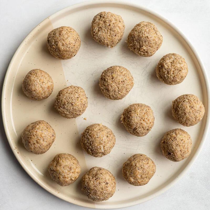 vegan meatballs on a large plate before they've been cooked