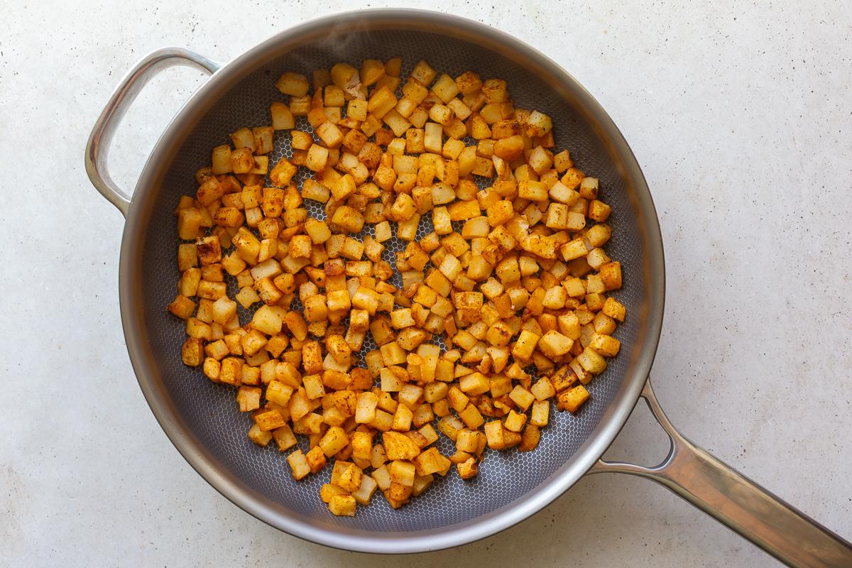 how to make vegetarian breakfast burritos: sautéing the hash browns