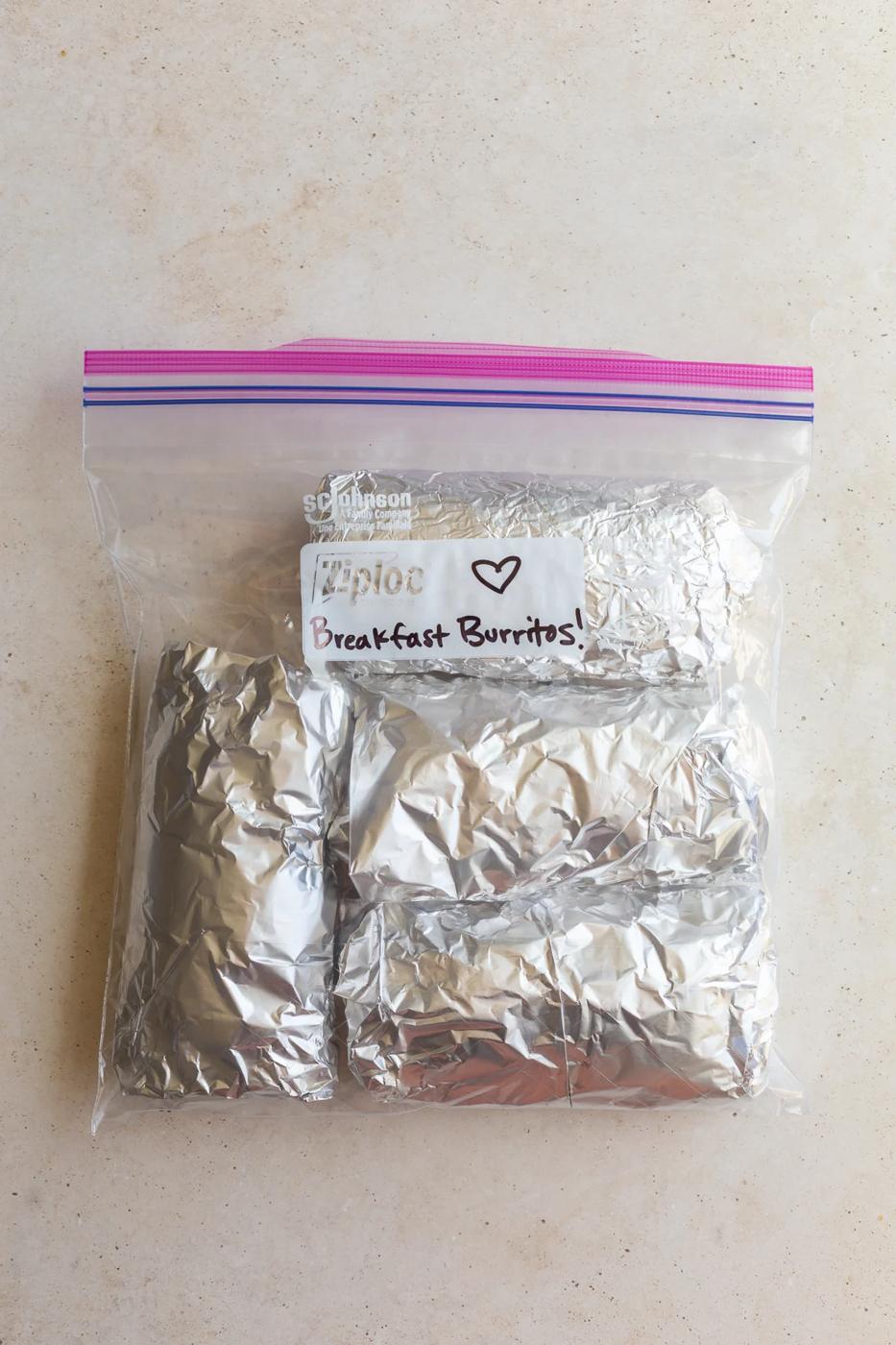 freezer breakfast burritos wrapped in foil and placed in a gallon baggie labeled "Breakfast burritos!"