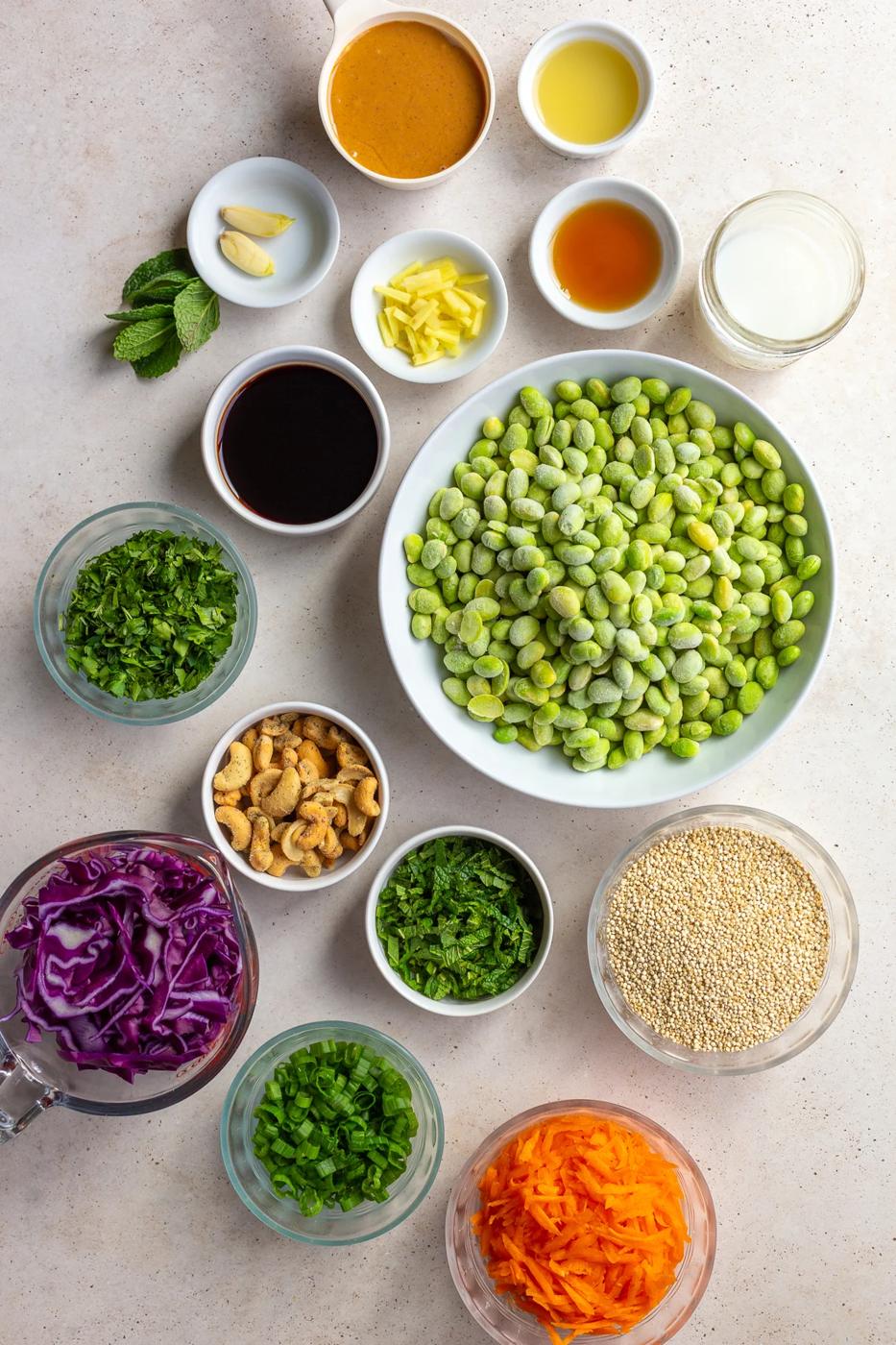 Ingredients for the edamame salad divided into small bowls.