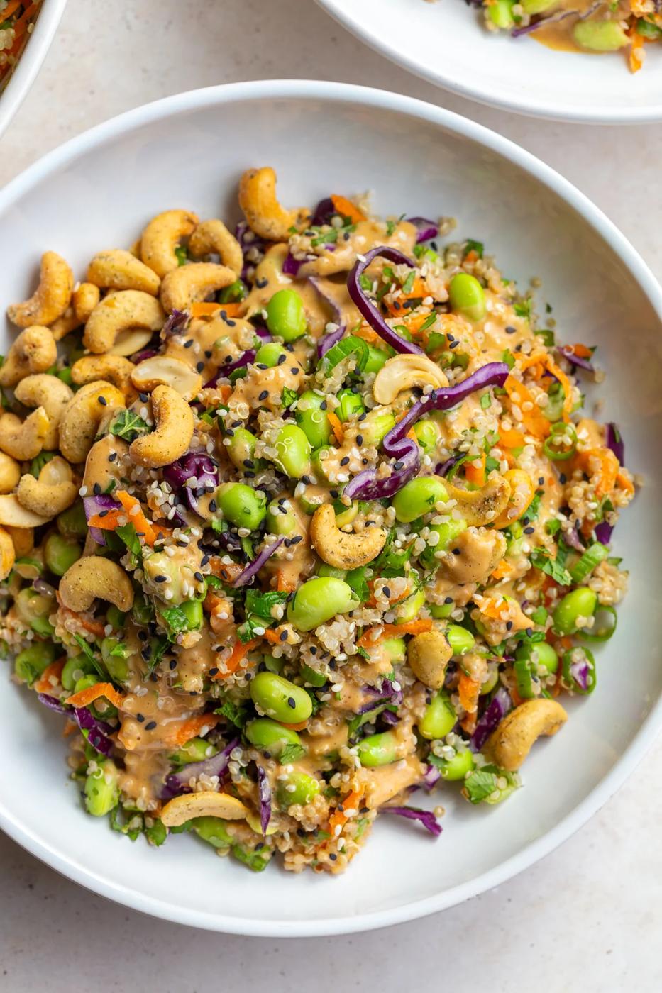 Edamame salad served in a white bowl with cashews.