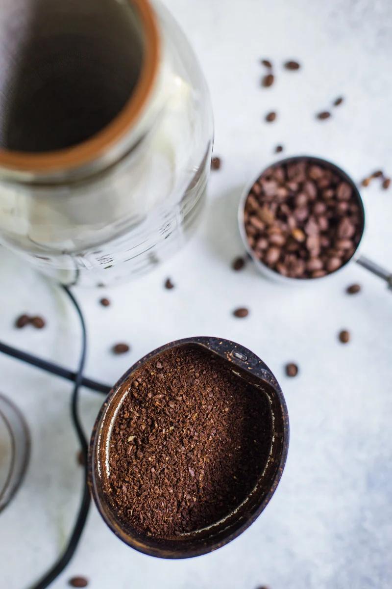 coffee beans being ground up in a coffee grinder