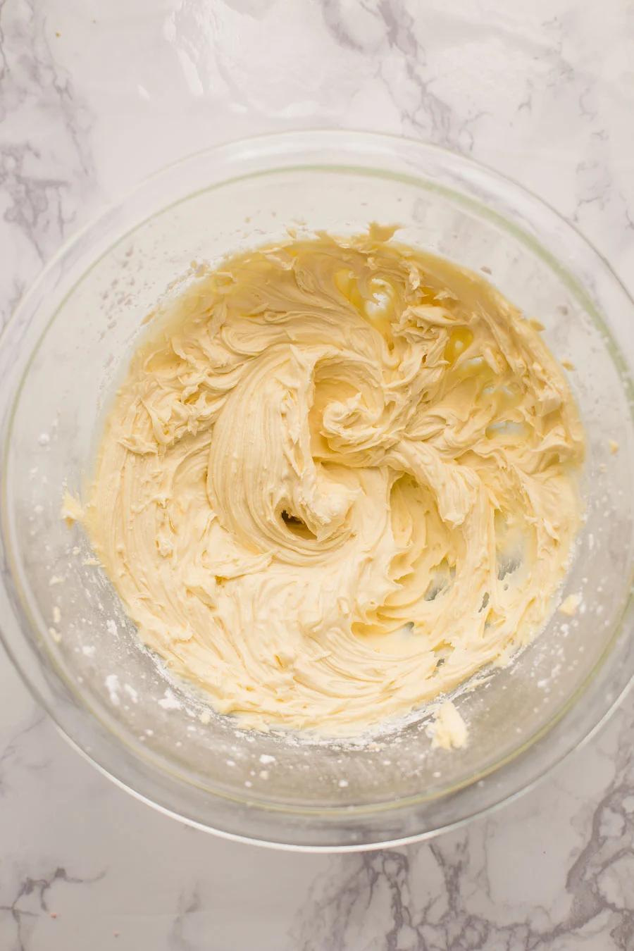 white frosting in a clear bowl