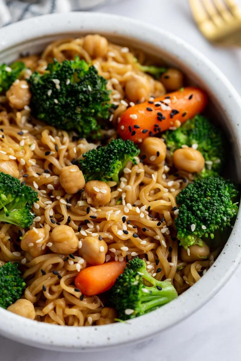 up close shot of ramen noodles with veggies and sprinkled with sesame seeds