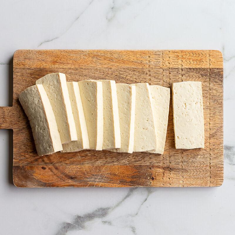 slabs of tofu on a wood cutting board