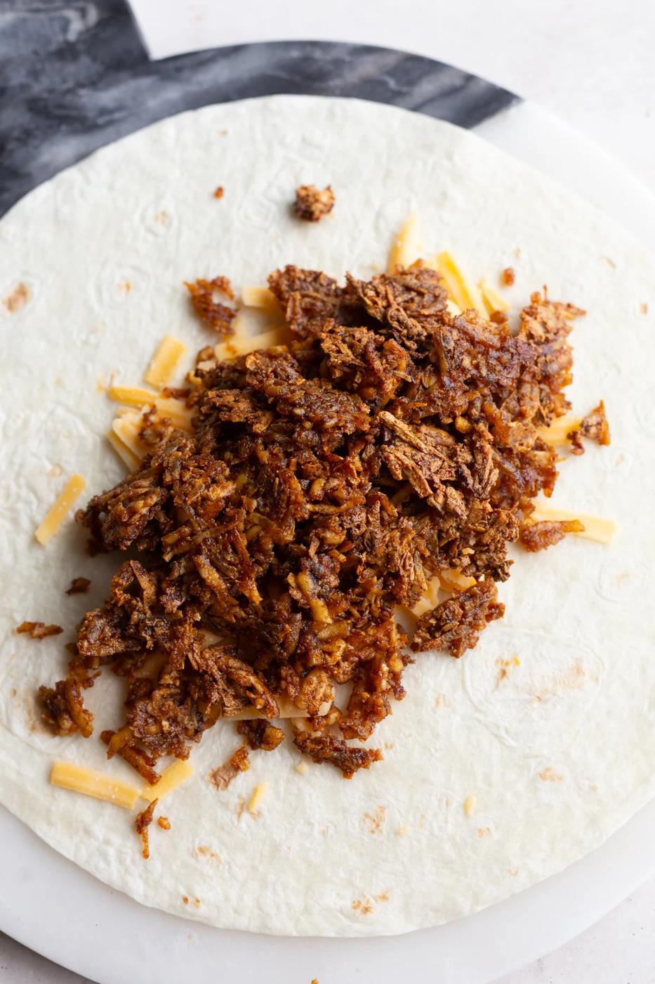 shredded taco tofu on a burrito