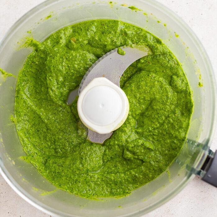 fresh from-scratch pesto blended up in a food processor base.