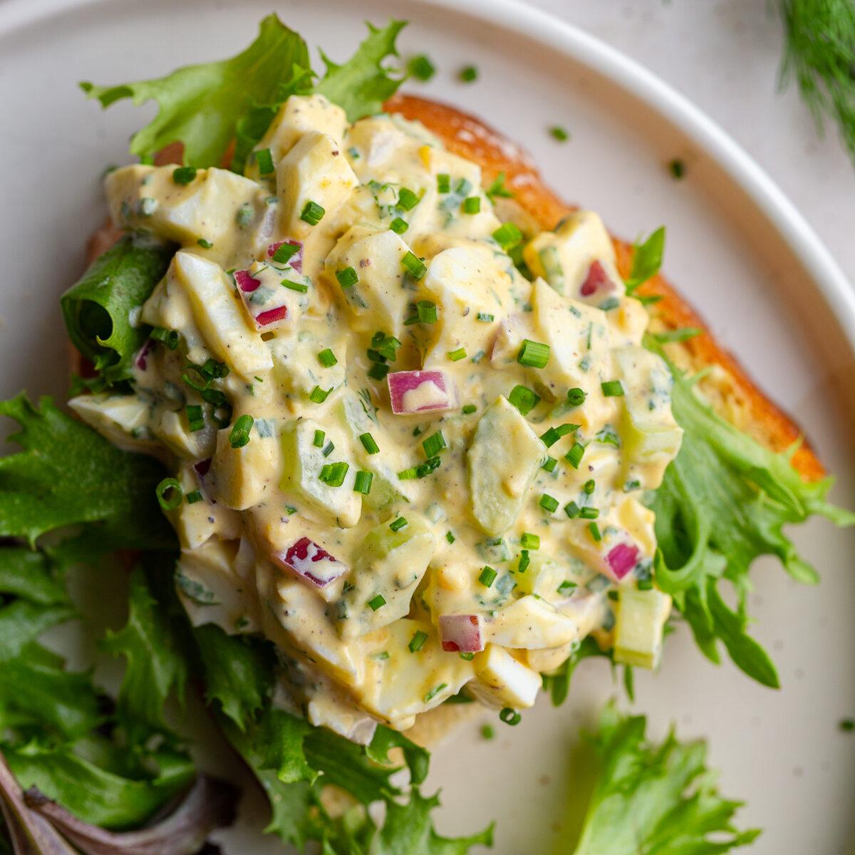 egg salad sandwich with greens on it