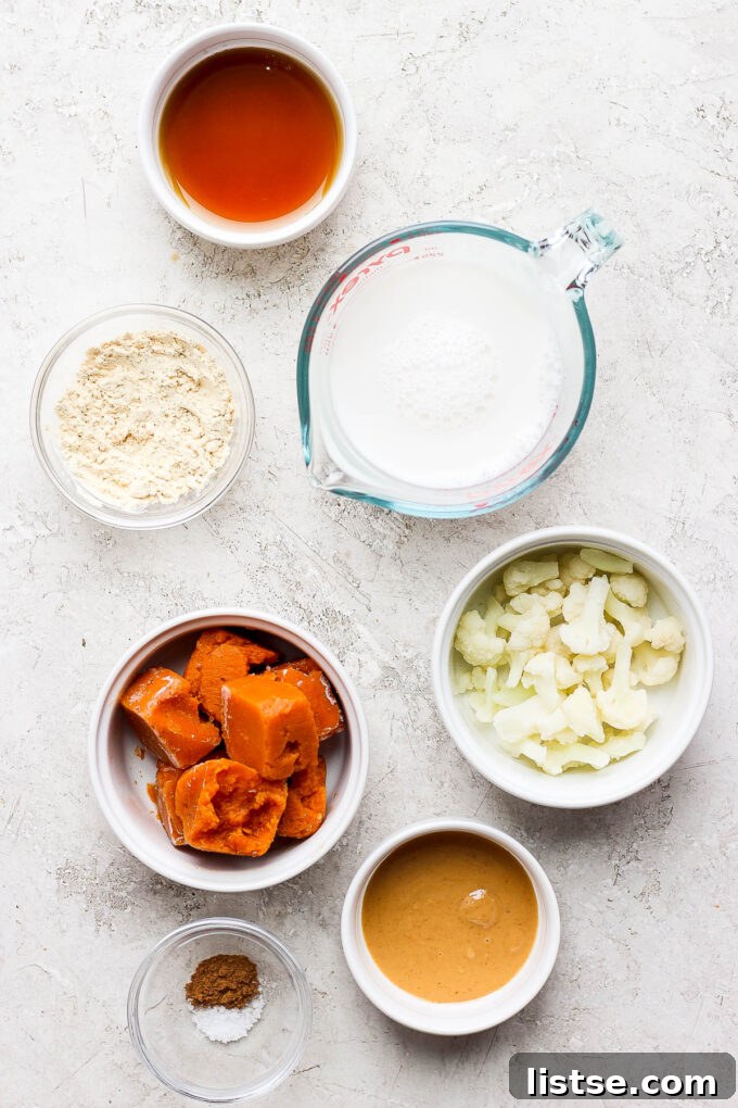 Ingredients for a pumpkin smoothie laid out in small bowls, ready for blending.