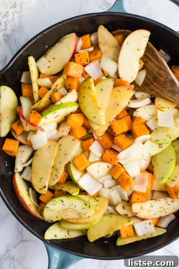 Healthy One Skillet Apple Cider Chicken, featuring tender chicken, sweet potatoes, and apples in a savory cider sauce, ideal for a quick autumn dinner.