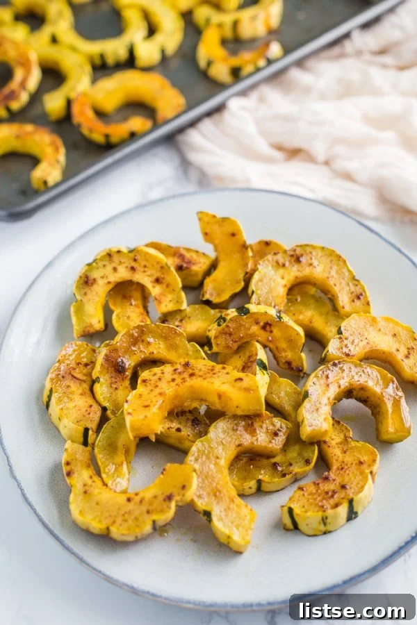Roasted Delicata Squash with fresh herbs on a white plate