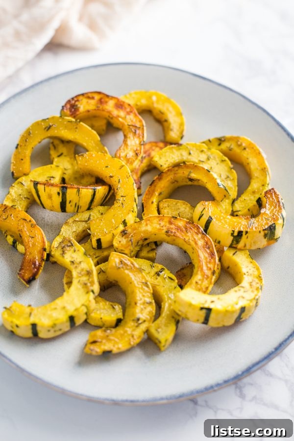 Raw delicata squash halved and prepared for roasting
