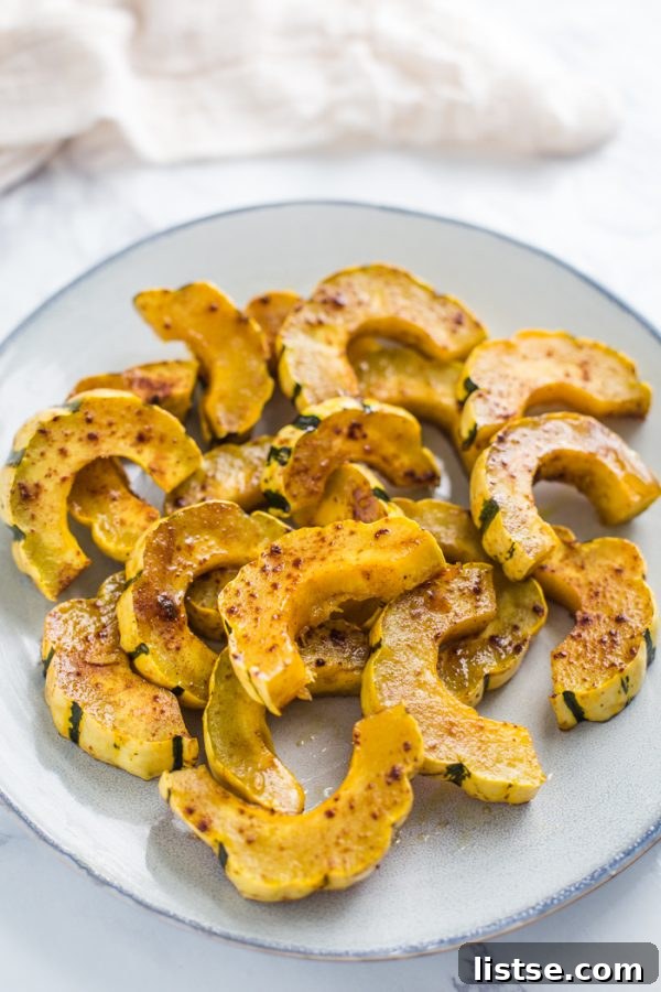 A mix of sweet and savory roasted delicata squash on a plate, ready to be served