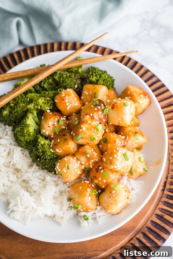 Crispy Tofu with Sweet Chile Sauce - a quick and easy VEGAN dinner that everyone will love! Golden brown and glazed with a vibrant sauce.