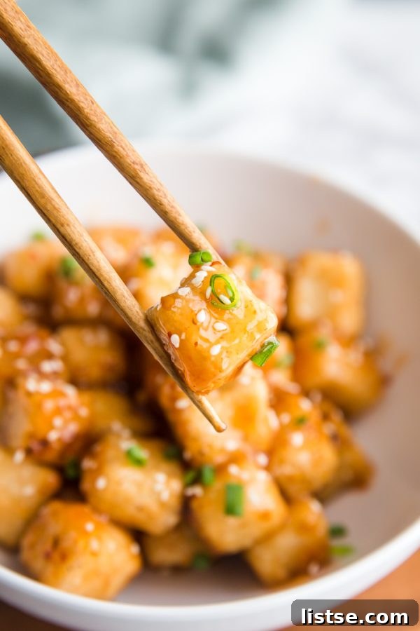 Close-up of Crispy Tofu with Sweet Chile Sauce, highlighting the crunchy exterior and glossy sauce.
