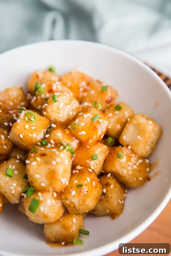 Batch of freshly fried crispy tofu cubes, ready to be tossed in sweet chile sauce.