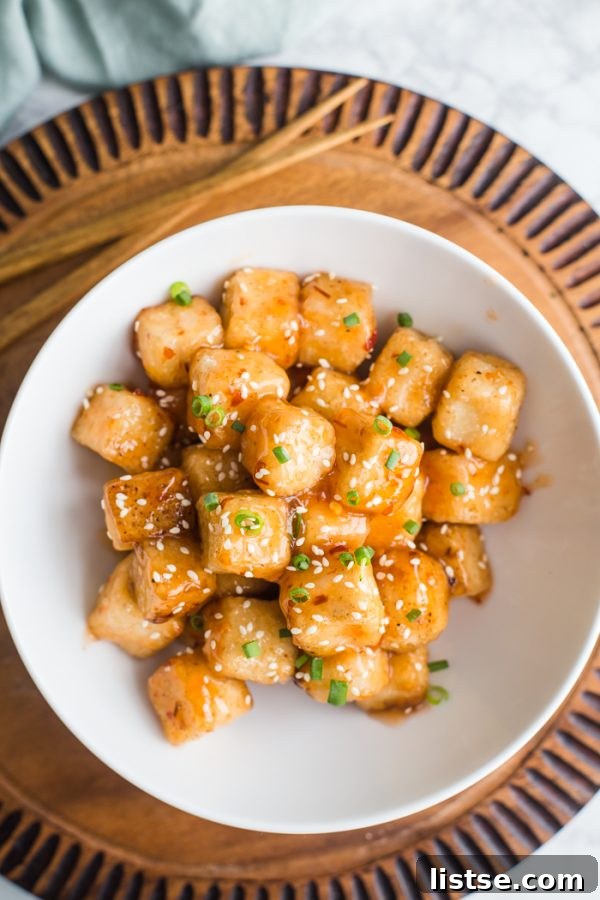A bowl of Crispy Tofu with Sweet Chile Sauce served alongside basmati rice and steamed broccoli.