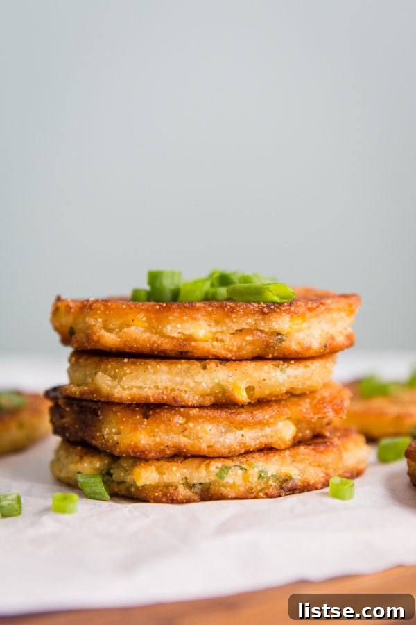 Deliciously crispy Vegan Corn Fritters served golden brown on a plate.