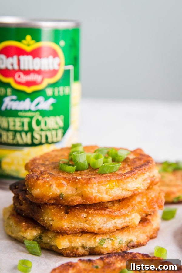 Close-up of golden Vegan Corn Fritters served on a rustic plate.