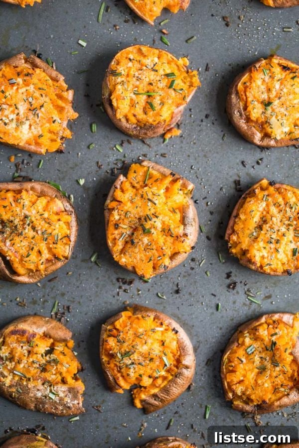 Sweet Potato Garlic Smash 3 Garlic Smashed Sweet Potatoes baking on a sheet