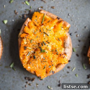 Sweet Potato Garlic Smash 7 smashed sweet potato round on a baking sheet topped with pepper