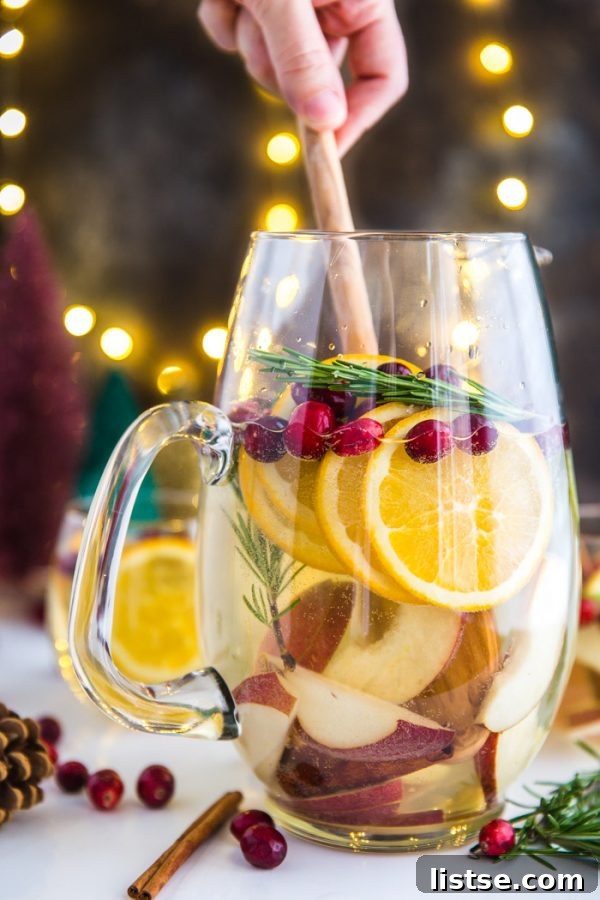 Fresh Ingredients for Holiday Sangria: Pears, Oranges, Cranberries, Rosemary, and Cinnamon Sticks.