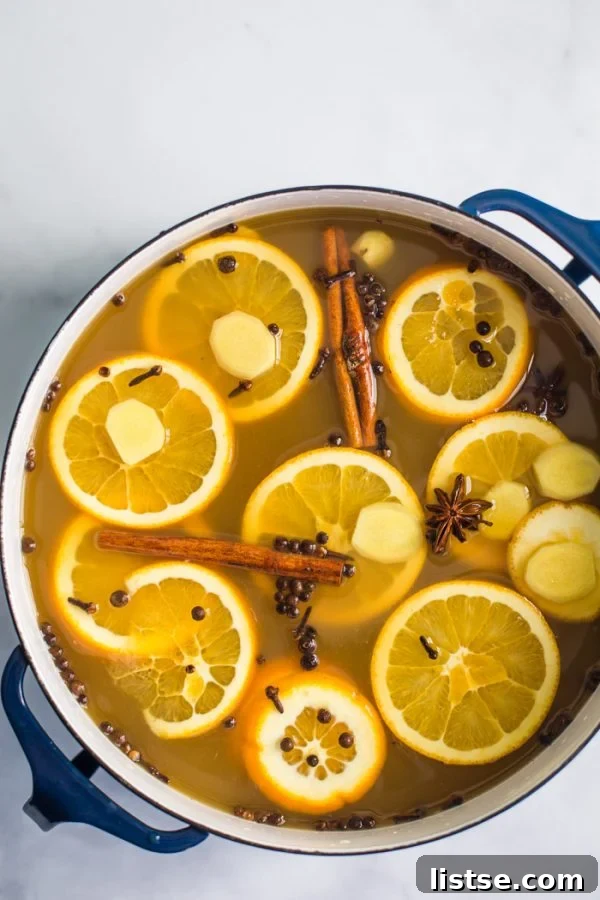 Festive slow cooker mulled cider garnished with orange and cinnamon sticks