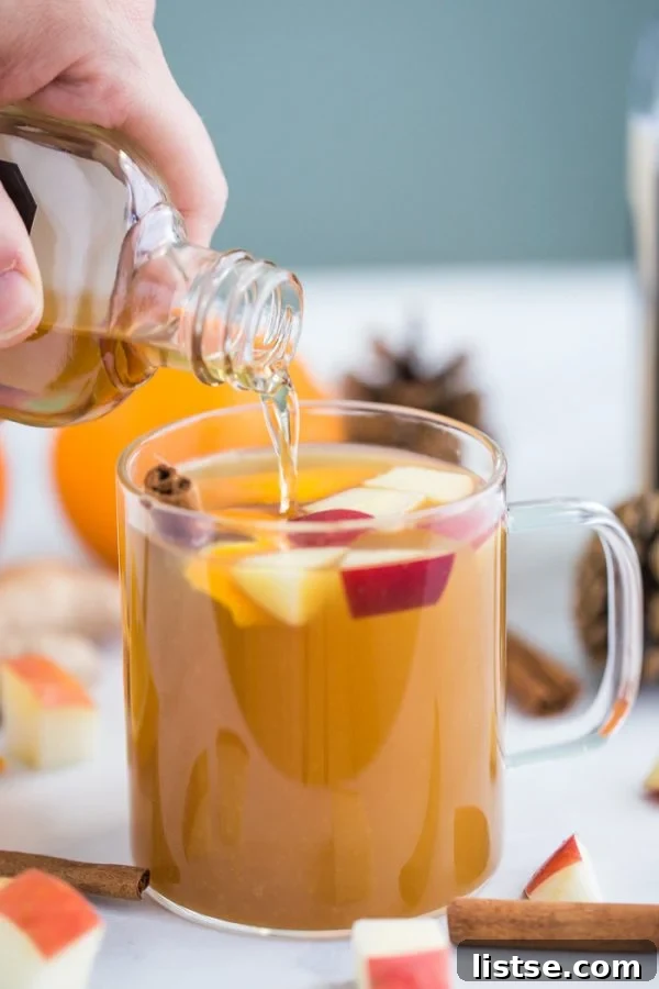 Close-up of slow cooker mulled cider with orange slices and spices