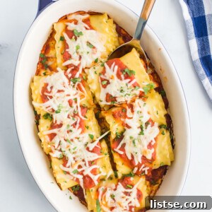 Prepared lasagna roll ups in a baking dish
