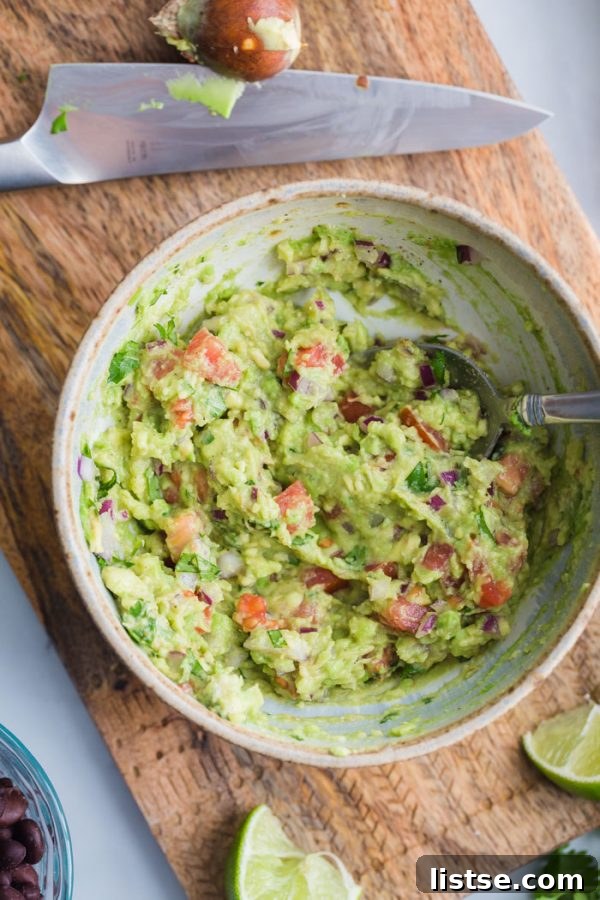 A close-up of a Guacamole Stuffed Sweet Potato, highlighting the vibrant colors and fresh ingredients ready to be enjoyed.