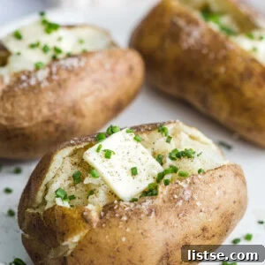 Fluffy Instant Pot Baked Potatoes 7 Perfectly baked potato topped with a pat of butter and fresh chives, a comforting meal prepared in the Instant Pot.
