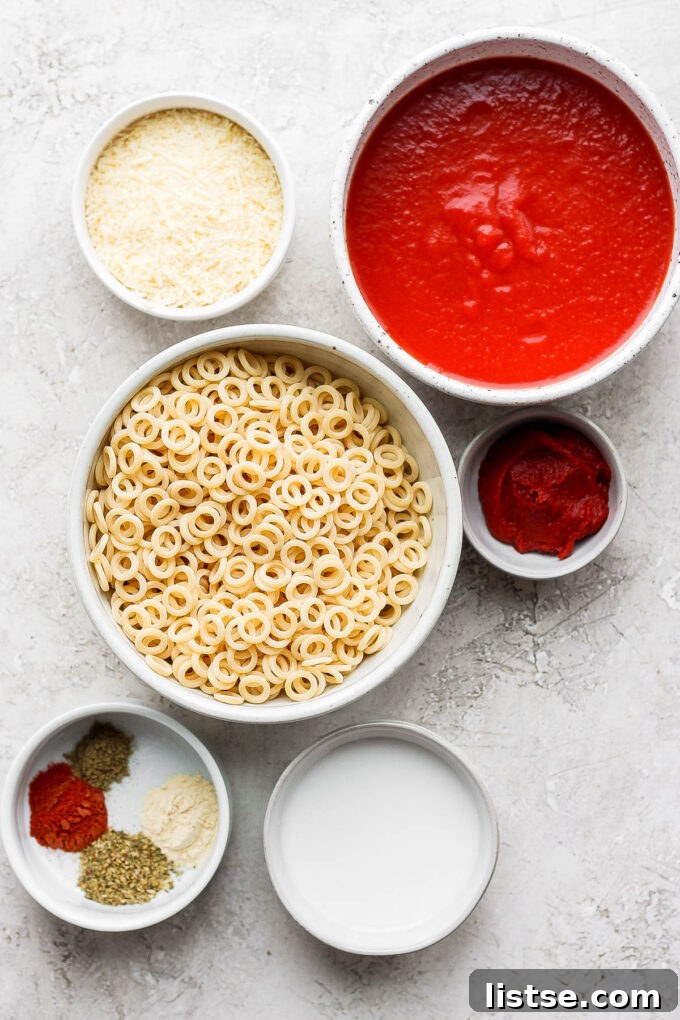 DIY Pasta Hoops 5 Various ingredients for homemade spaghettios, neatly arranged in small bowls on a wooden surface.