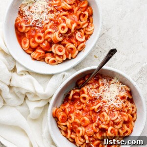 Two white bowls filled with homemade spaghettios, ready to be served.