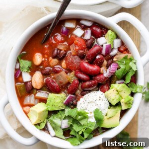 Hearty Slow Cooker Plant-Based Chili 8 vegan crockpot chili in a white bowl with a spoon