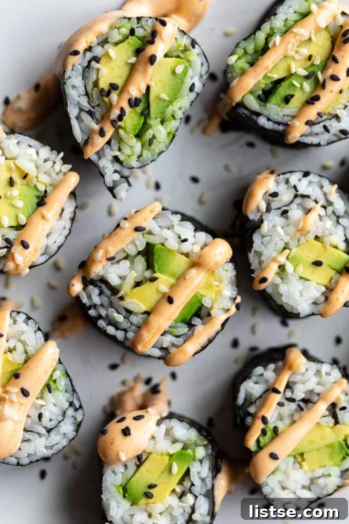 Avocado sushi roll topped with spicy mayo, a classic and delicious vegan sushi option.