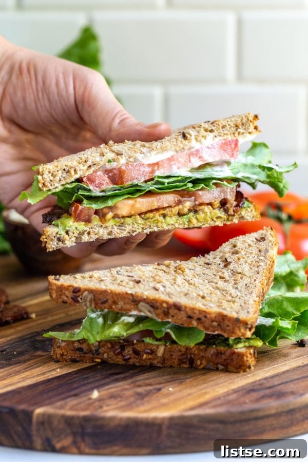 Tempeh bacon sandwich with fresh lettuce and tomato, a delicious vegan lunch.