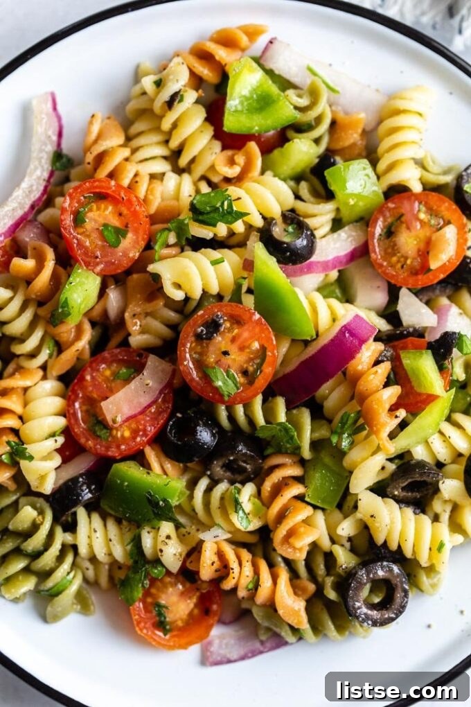 Veggie pasta salad with colored noodles, a vibrant and refreshing dish.