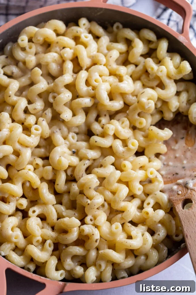 Creamy cavatappi pasta in a large skillet, a rich and comforting vegan meal.