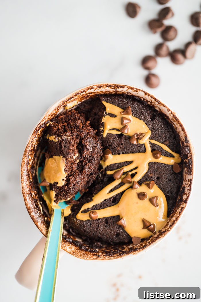 chocolate cake in a mug with a spoon, showing creamy texture
