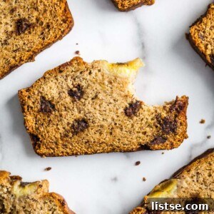 A freshly baked loaf of vegan chocolate chip banana bread, golden brown and inviting.