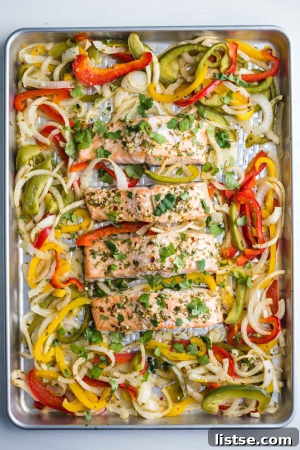 A vibrant close-up of the cooked Sheet Pan Garlic Lime Salmon, ready to be served, showing its golden-brown exterior and flaky texture.