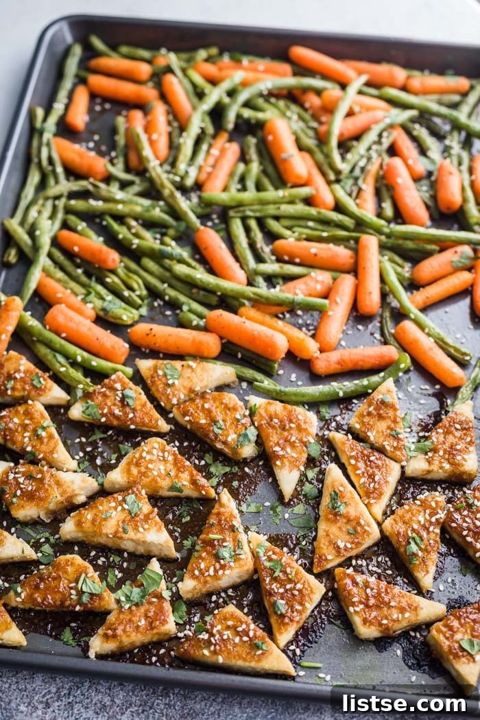 Crispy baked tofu and vibrant roasted vegetables on a sheet pan, ready to serve